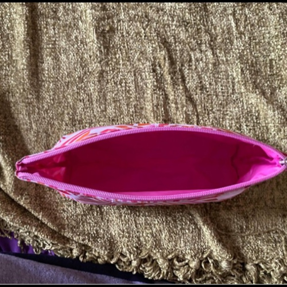 Pink and orange makeup bag with a groovy print